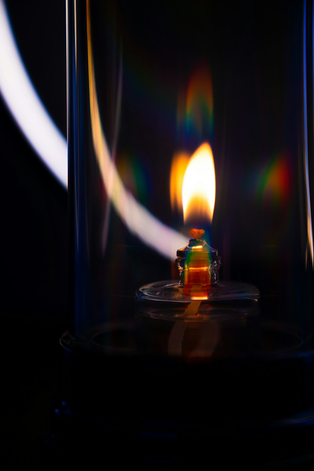 lighted candle in clear glass