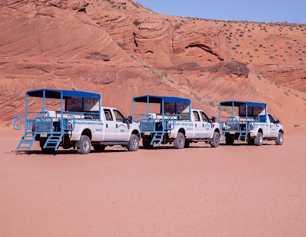 white and blue car on brown sand