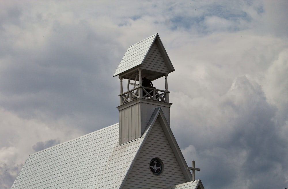 white and black concrete building under white clouds during daytime