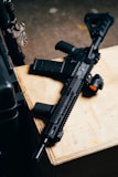 black rifle on brown wooden table