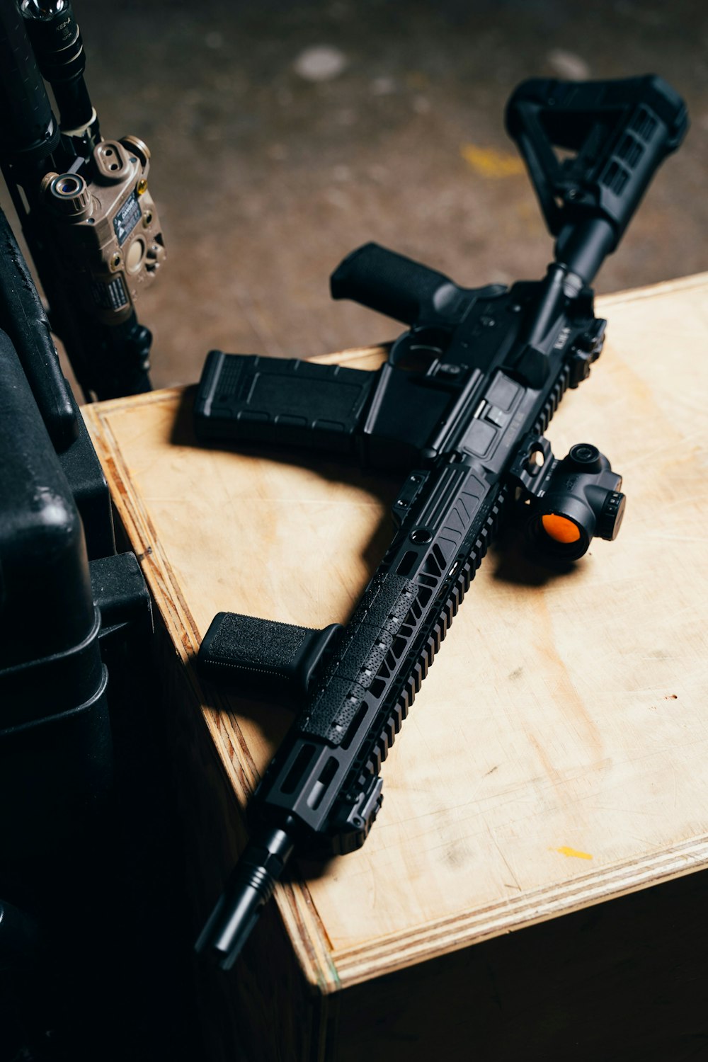 black rifle on brown wooden table