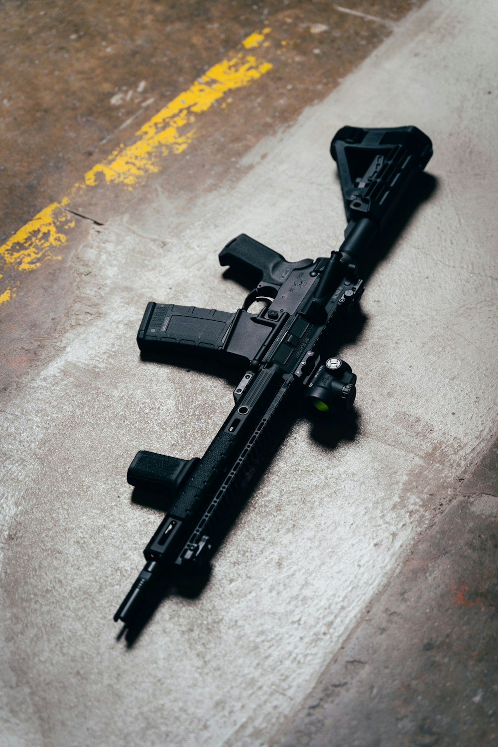 black rifle on brown wooden table