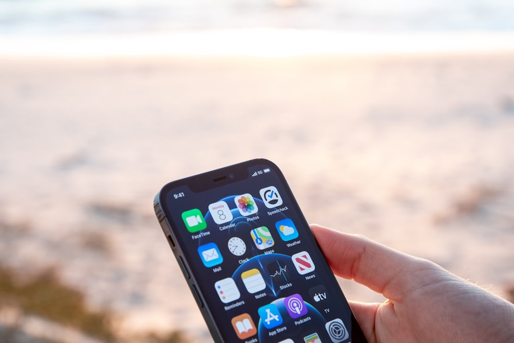 person holding black iphone 4