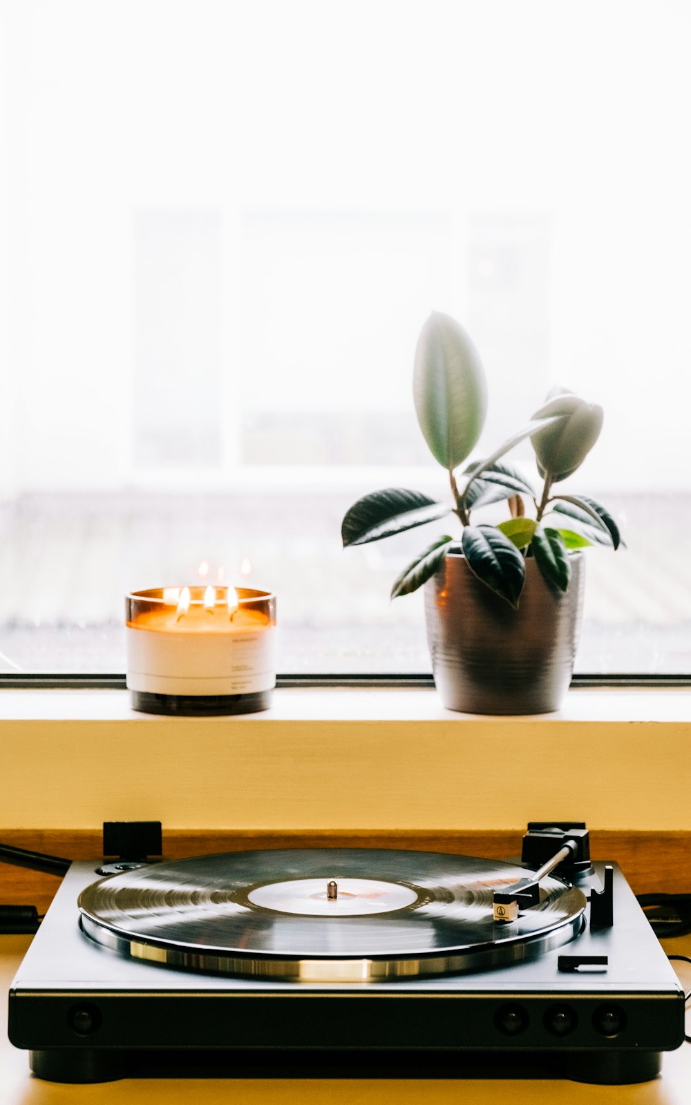 white candle on white ceramic holder