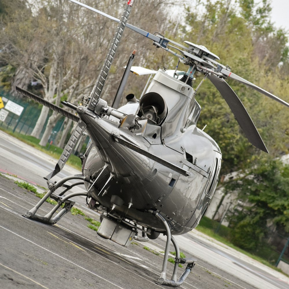 black helicopter on gray asphalt road during daytime