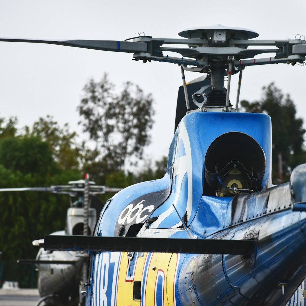 blue and black helicopter in close up photography during daytime
