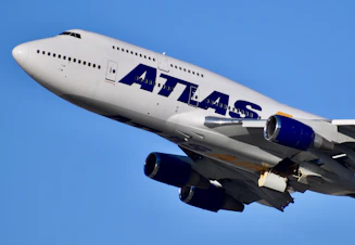 white and blue passenger plane in the sky