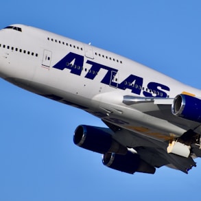 white and blue passenger plane in the sky