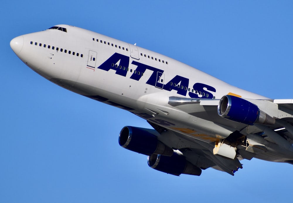 white and blue passenger plane in the sky