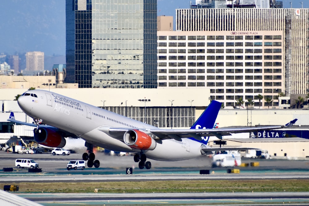 white and blue passenger plane on airport during daytime