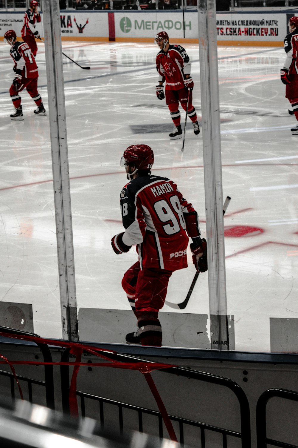 man in red and white ice hockey jersey shirt and helmet