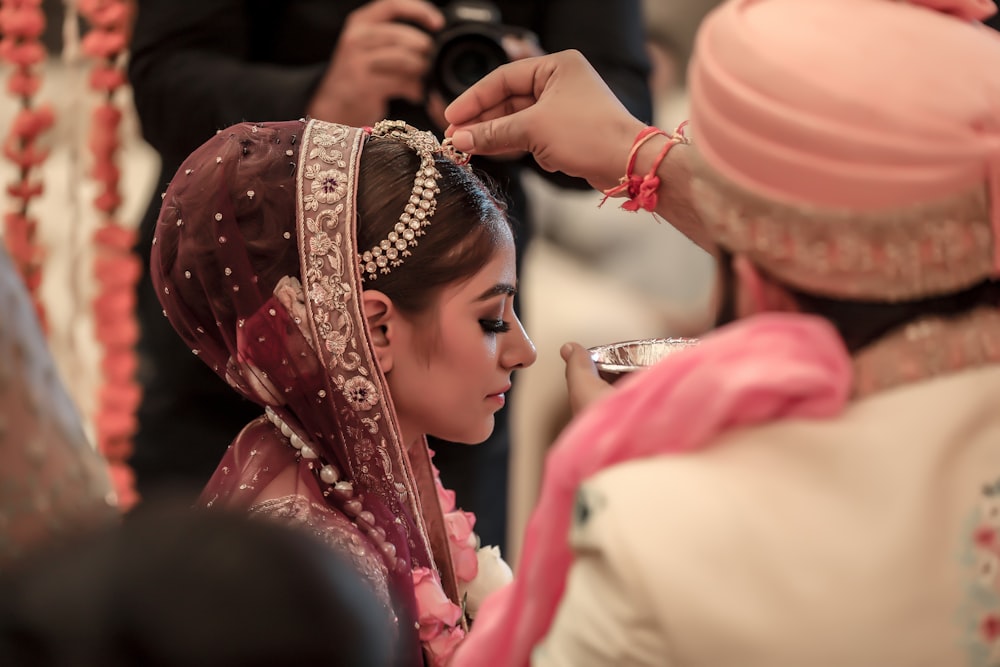 woman in pink and gold hijab