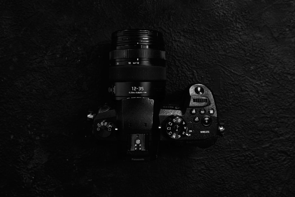 black sony dslr camera on black surface