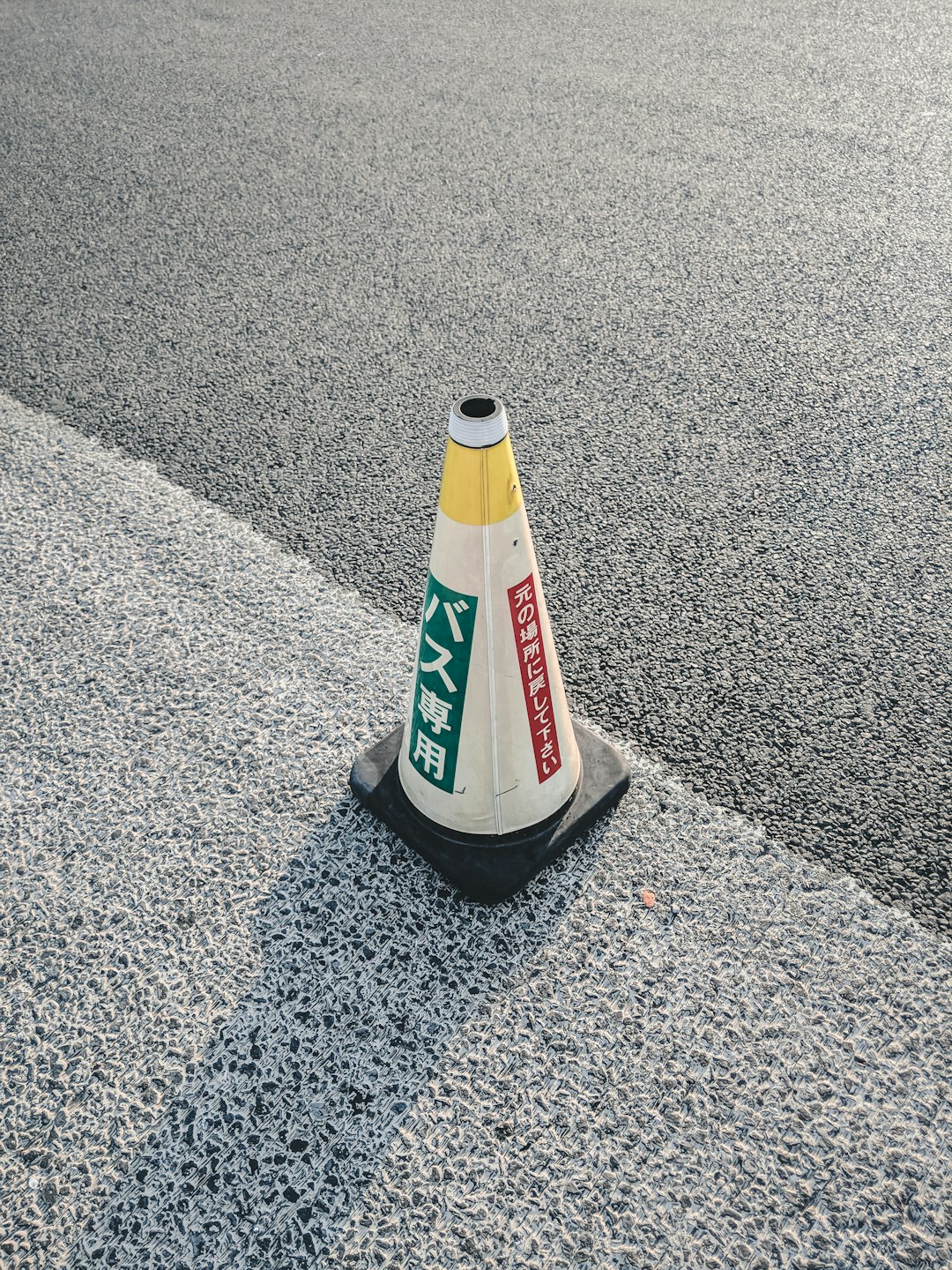 white and red bottle on gray concrete floor