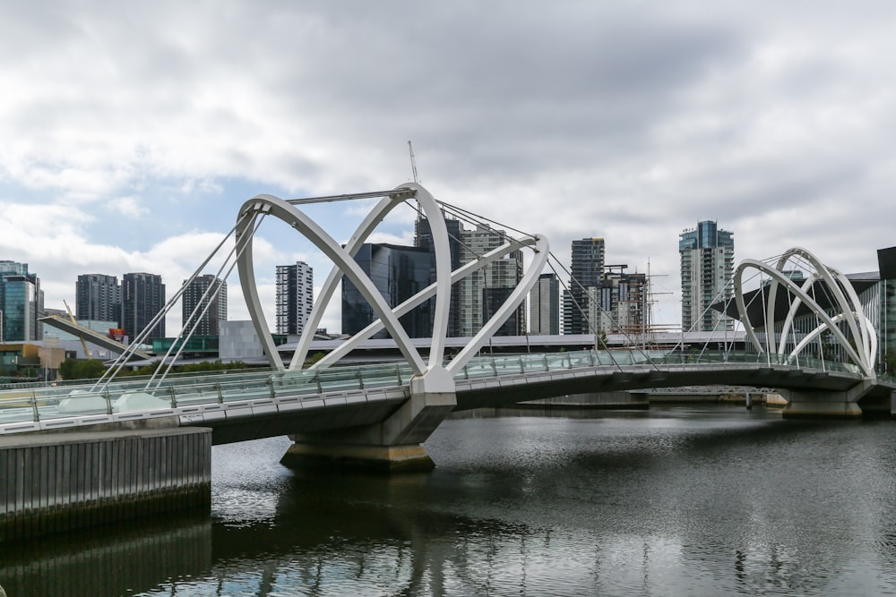 white bridge over river under cloudy sky during daytime