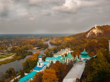 A panoramic view of an Orthodox monastery courtyard during golden hour.