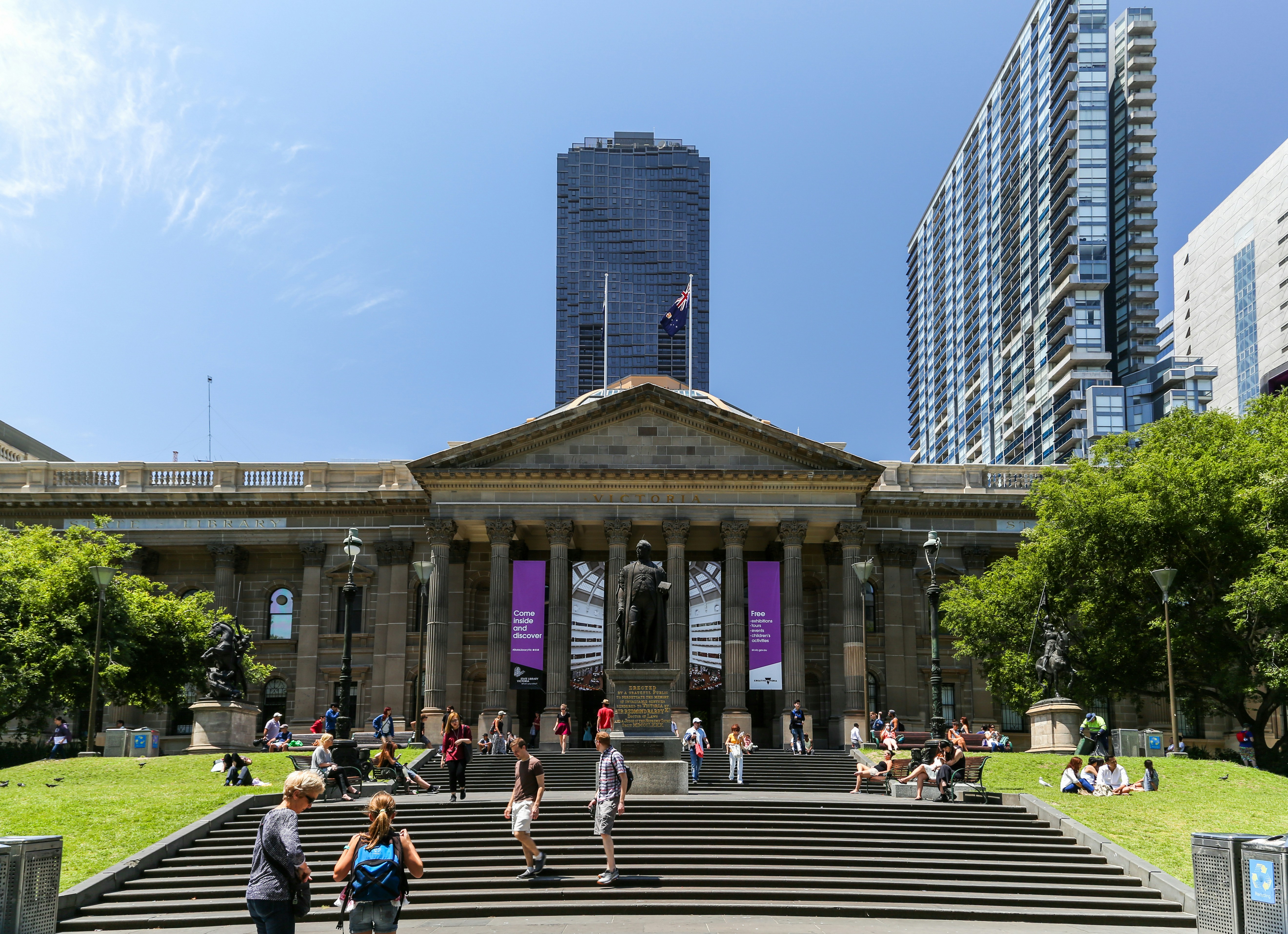 people sitting on bench near building during daytime