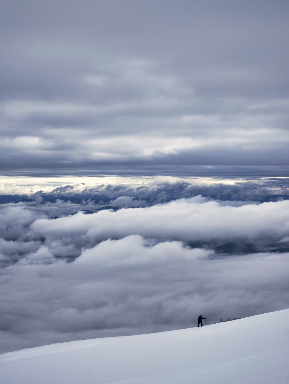 a person standing on top of a snow covered slope