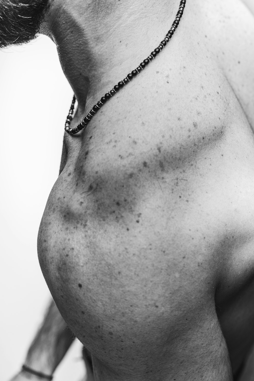 grayscale photo of woman wearing silver necklace