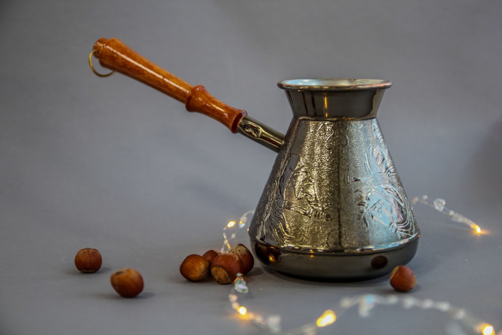 stainless steel teapot on brown round fruit