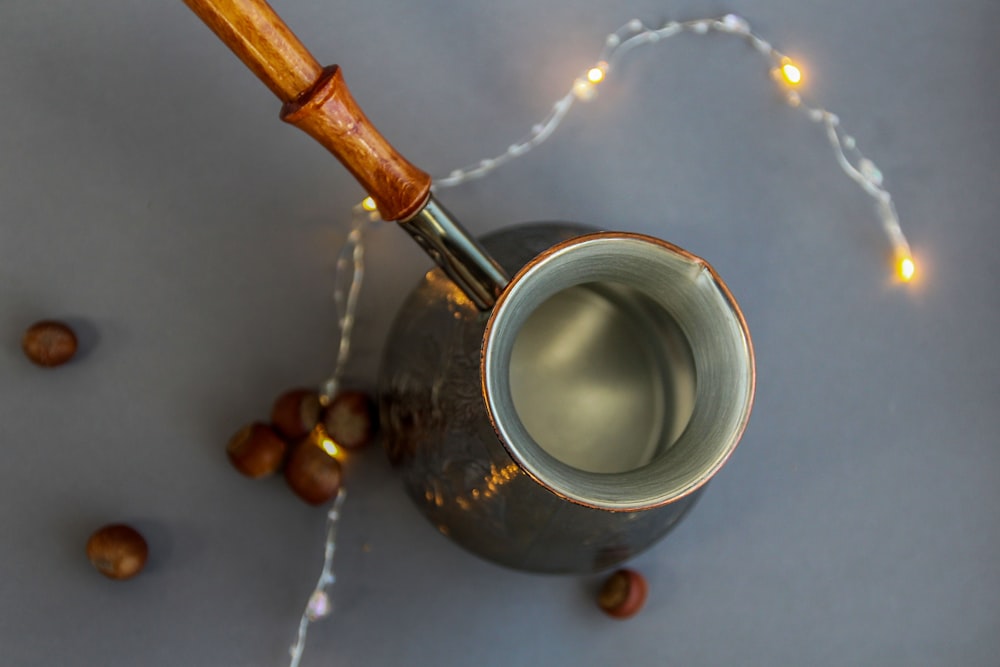 silver and brown round container