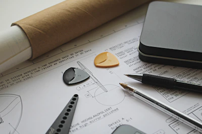 Modern office workspace with architectural blueprints and engineering tools.