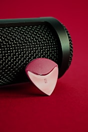 black and red speaker on red textile