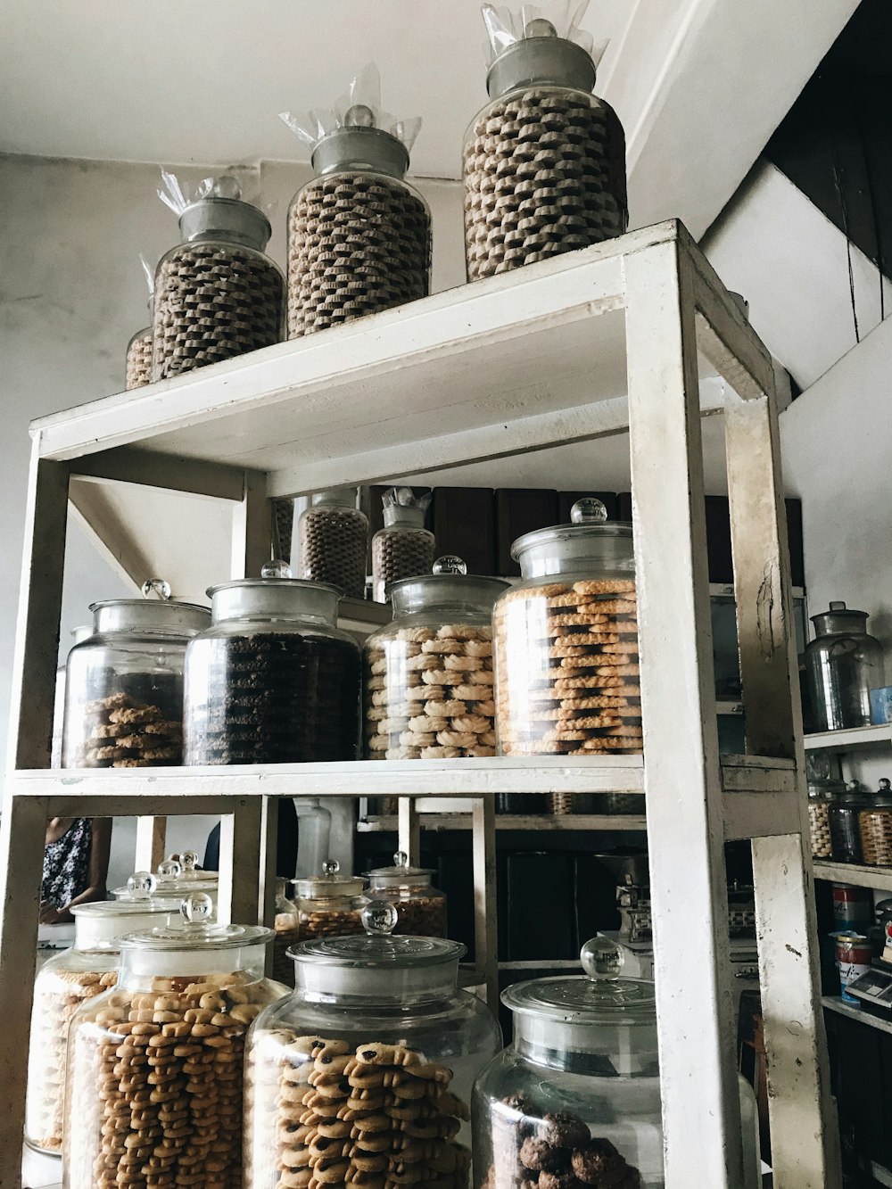 a shelf filled with lots of jars and containers