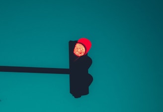 red stop light on green background