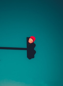 red stop light on green background