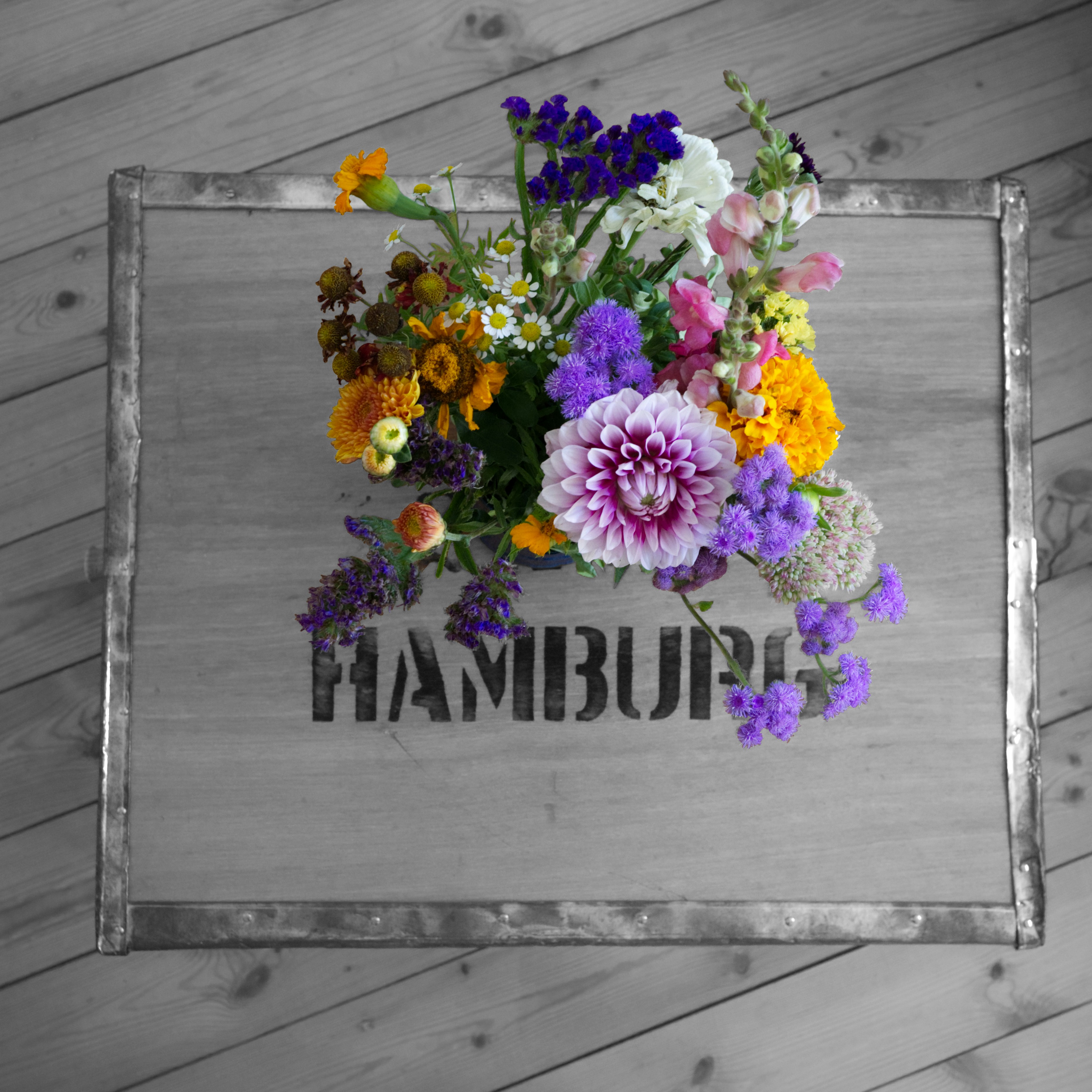 A bouquet of flowers on an upcycled industrial box, originally used for shipping tea to Hamburg