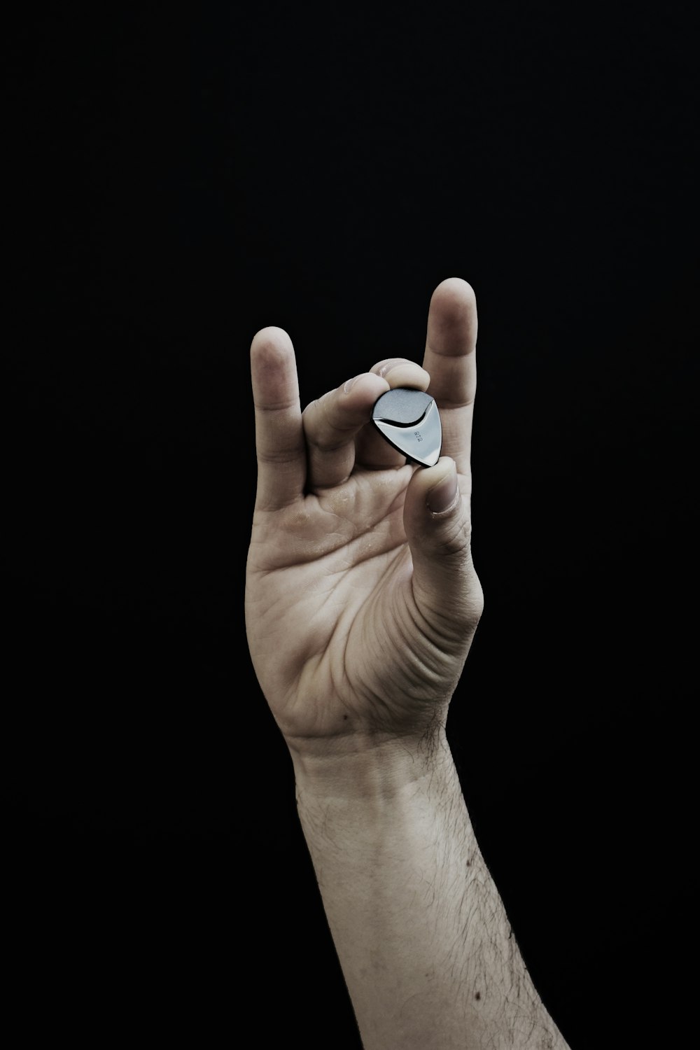 person holding white oval ornament