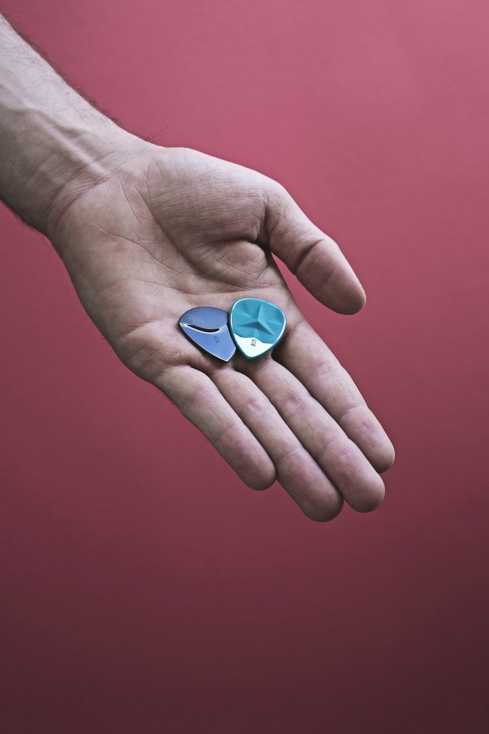 person holding blue heart ornament