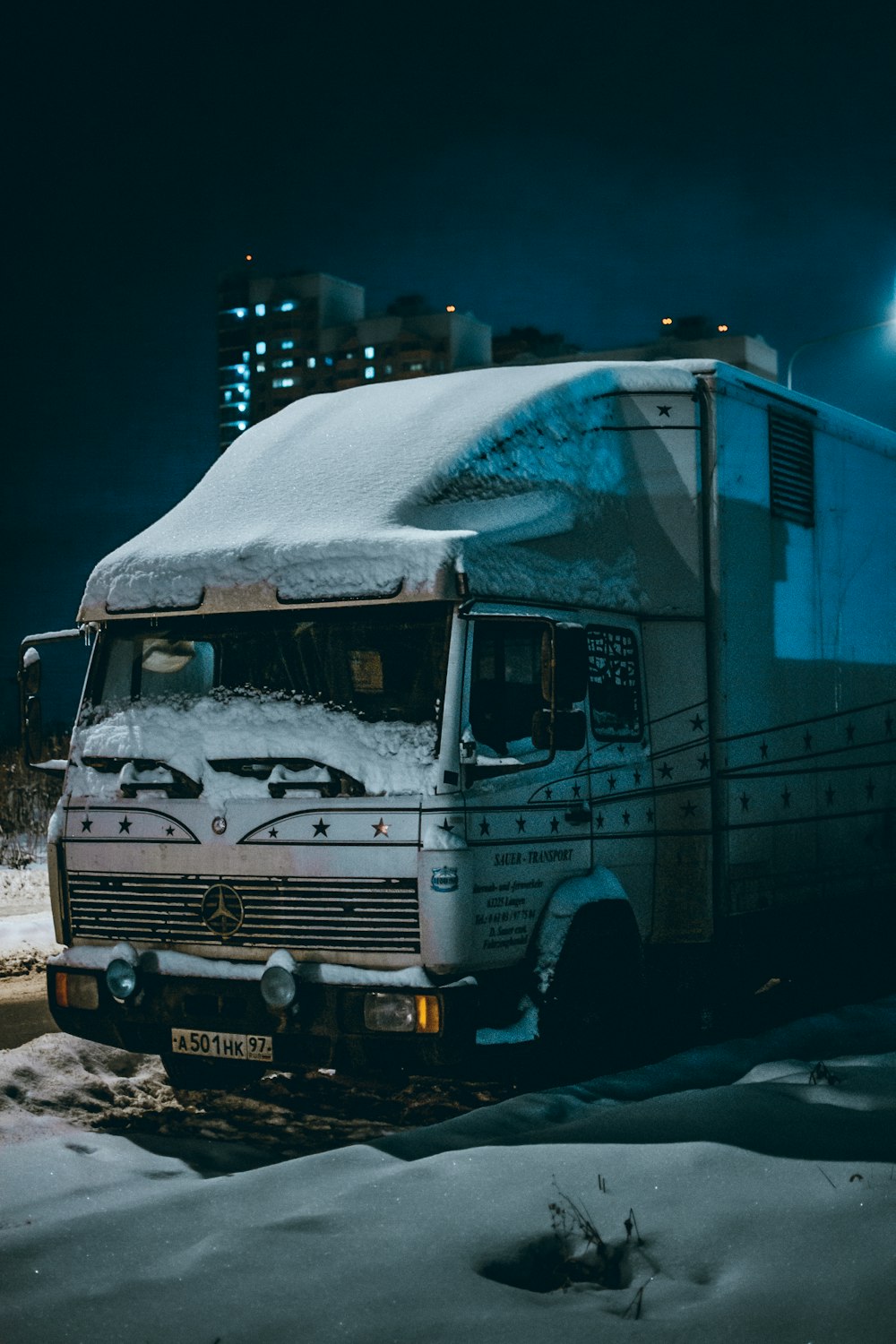 white and blue truck on road during daytime