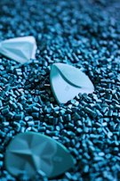 white plastic container on green beads