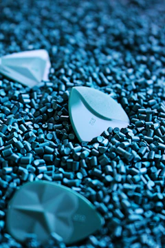 white plastic container on green beads