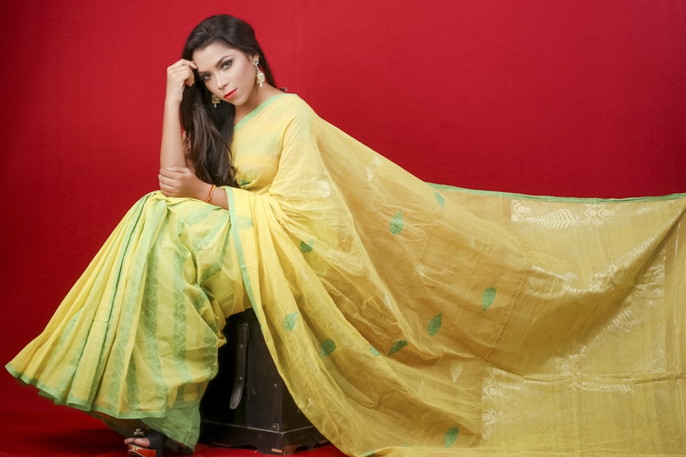 woman in yellow dress sitting on chair