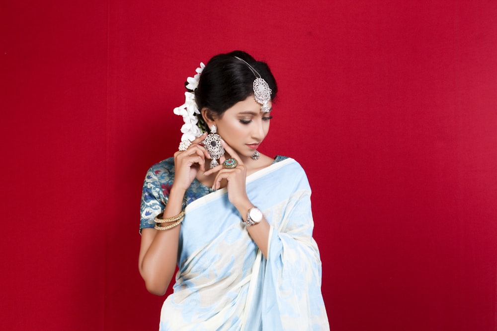 woman in blue dress wearing white floral headdress