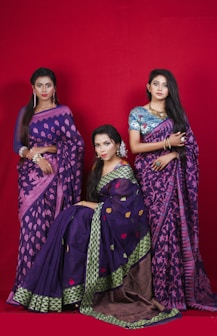 3 women in purple and pink sari