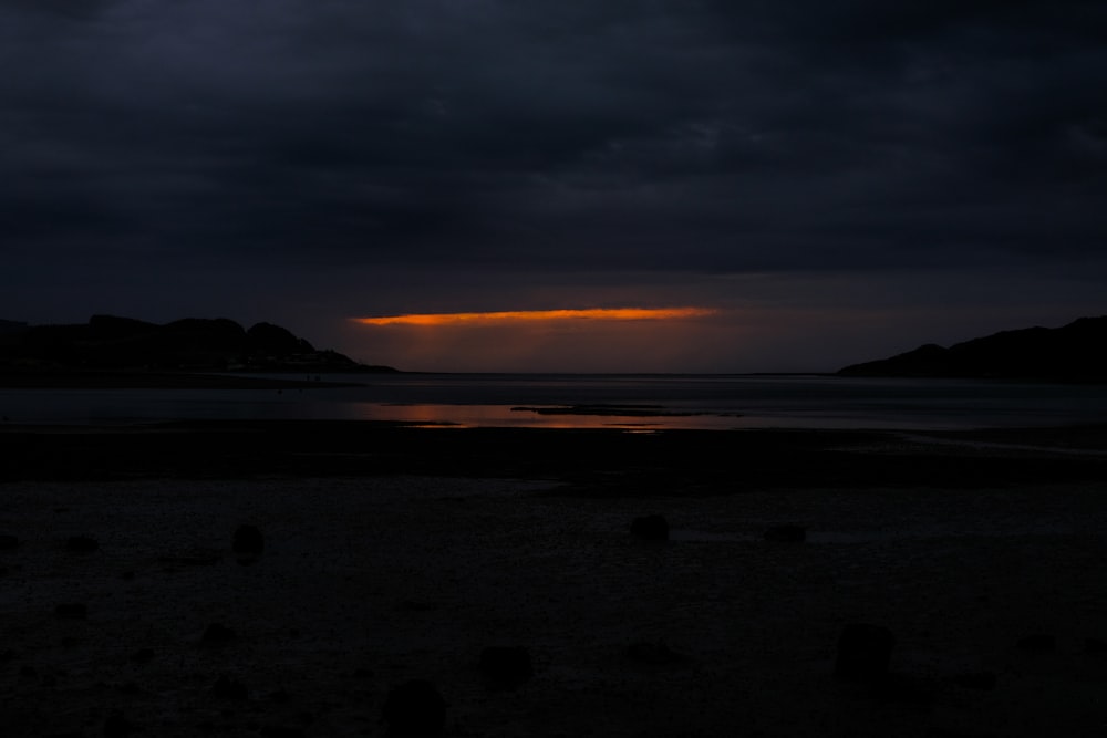 body of water during sunset