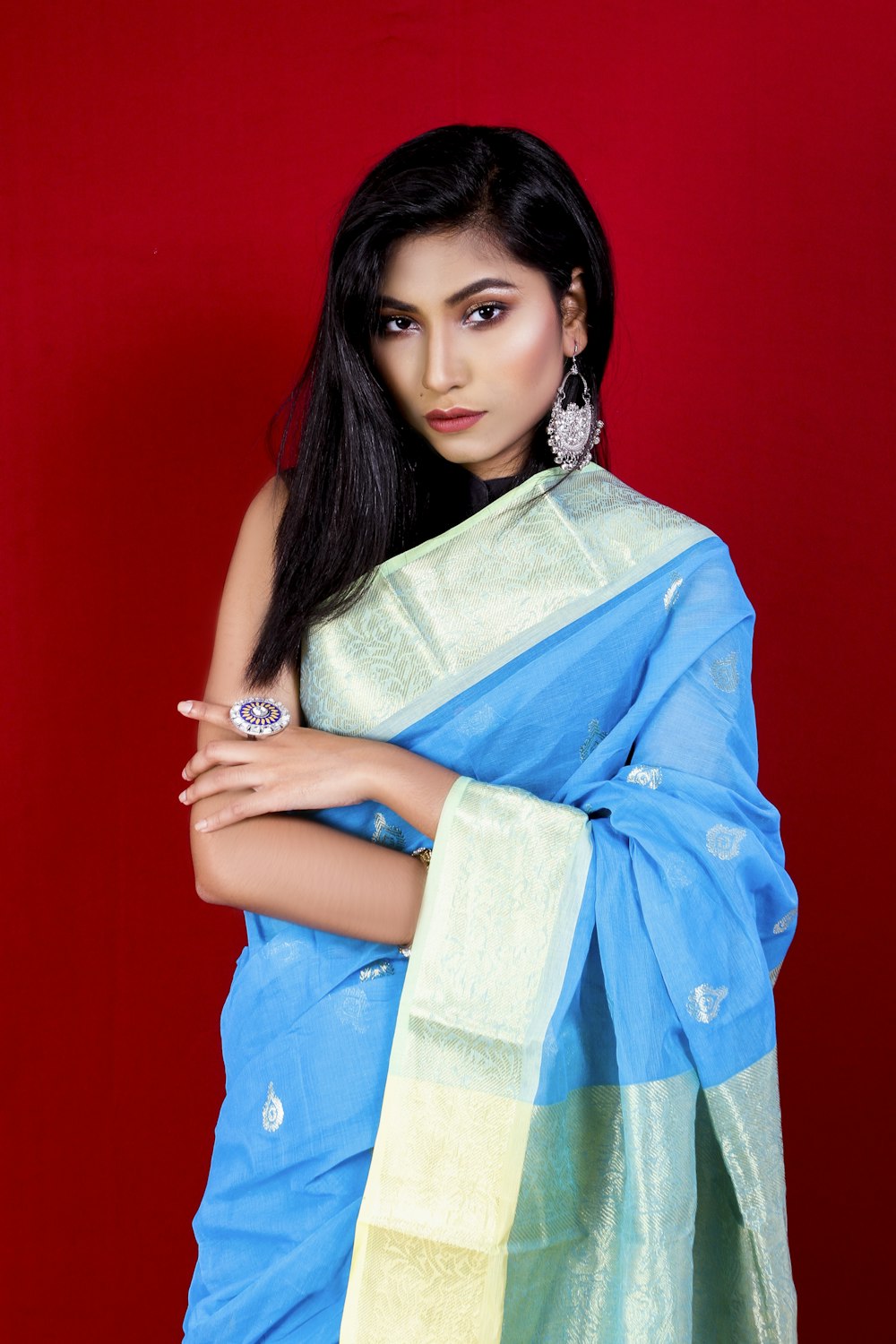 woman in blue and white floral dress holding brown textile