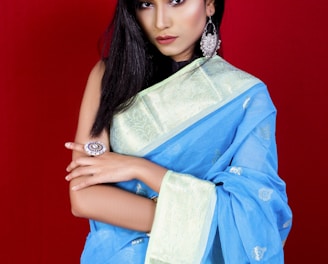 woman in blue and white floral dress holding brown textile