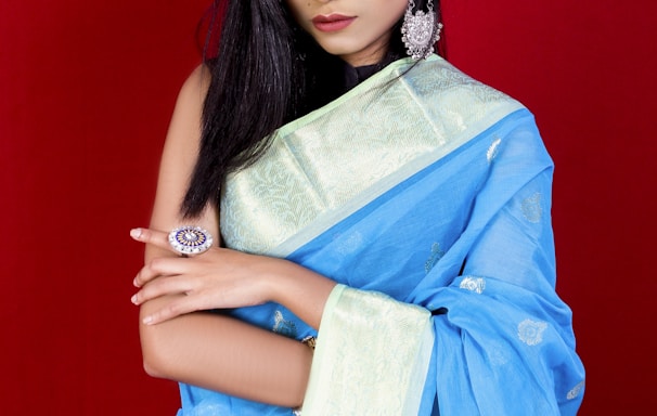 woman in blue and white floral dress holding brown textile