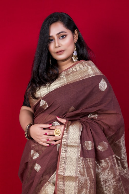 woman in brown and white floral sari