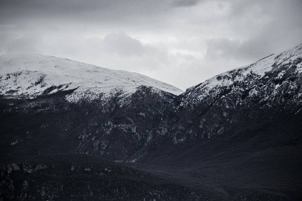 snow covered mountain under cloudy sky during daytime