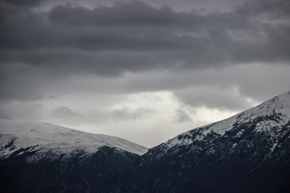 snow covered mountain under cloudy sky during daytime