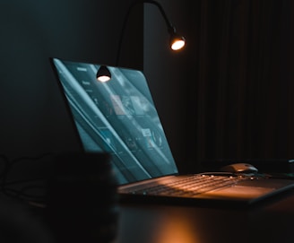 silver macbook on brown wooden table