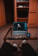 black laptop computer on brown wooden table