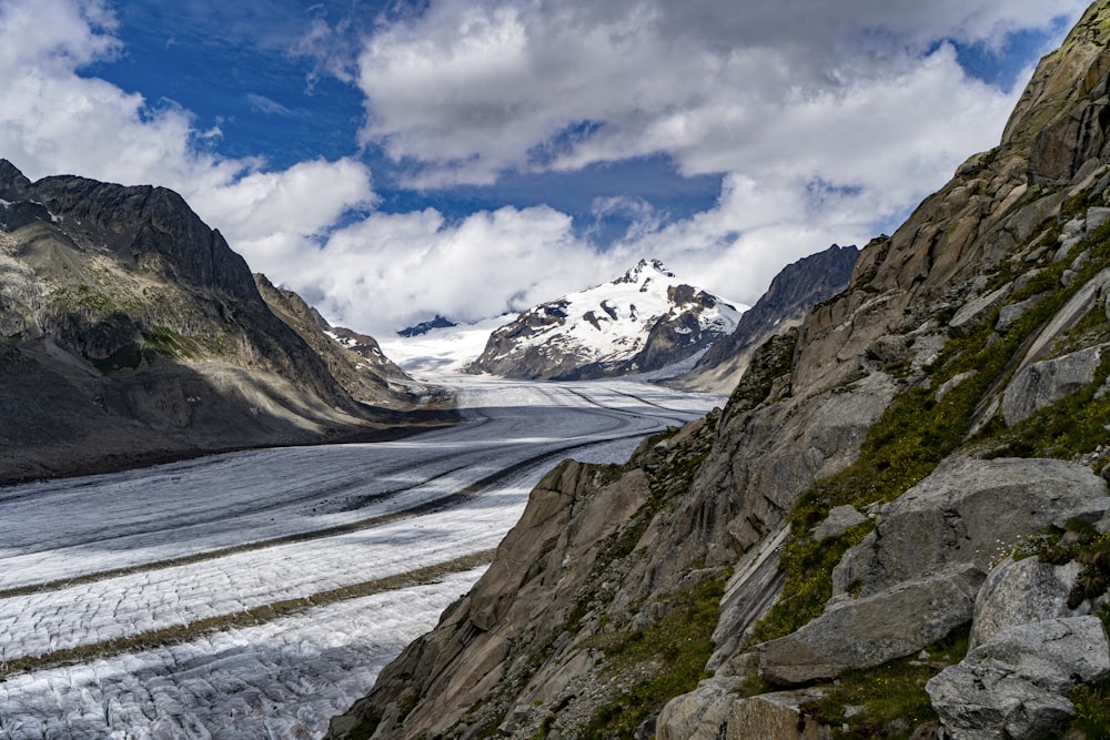 snow covered mountain under cloudy sky during daytime