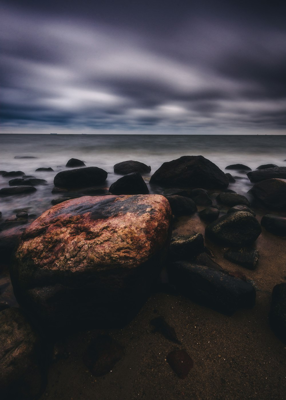 gray and black rocks on seashore